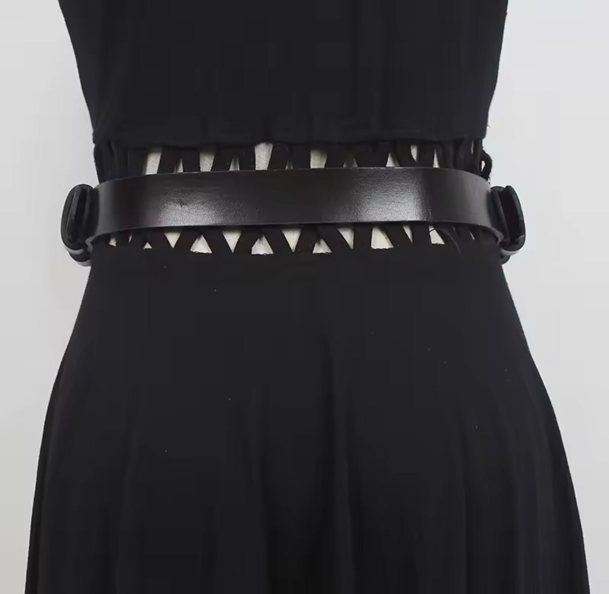 Black dress with a unique belt design on a white background