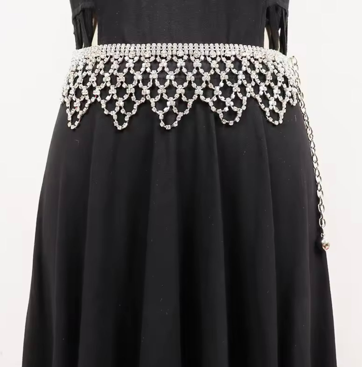 Black dress with a decorative white beaded waistband on a white background