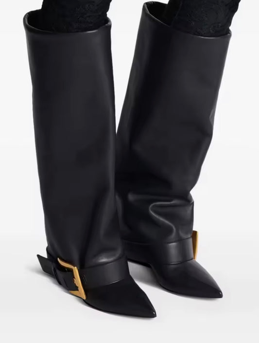 Black knee-high boots with gold buckles on a white background