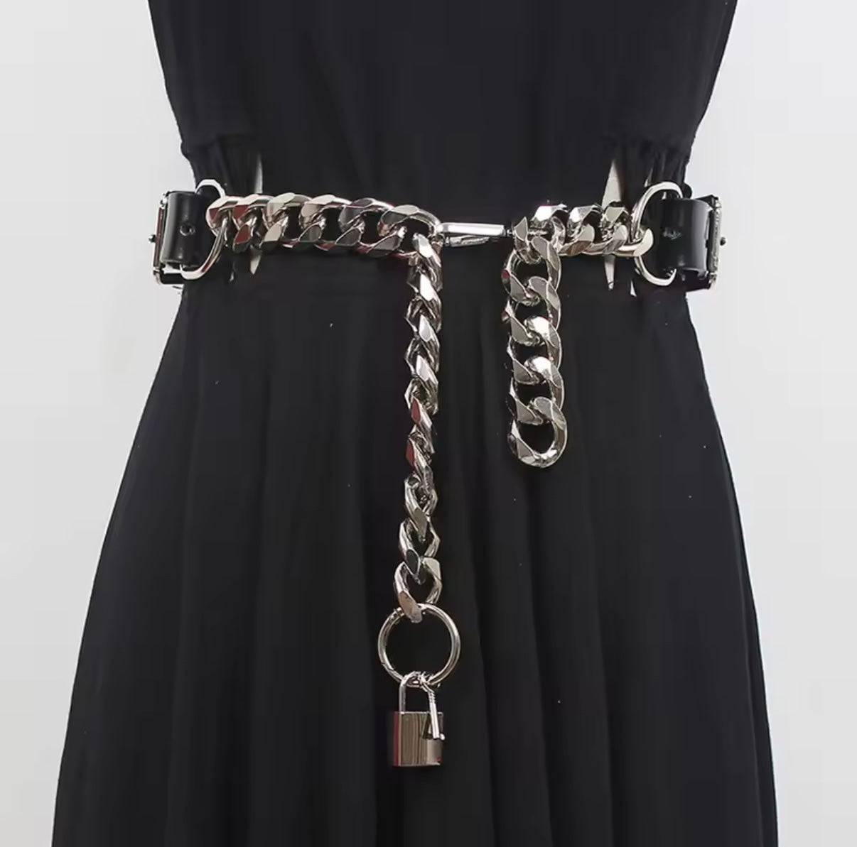 Black dress with a silver chain belt featuring a padlock on a white background