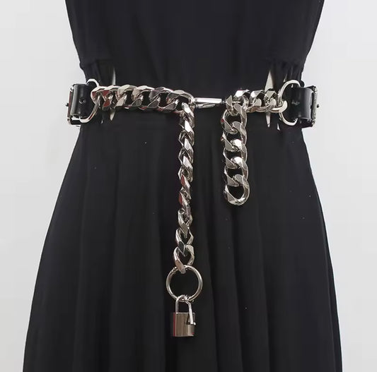 Black dress with a silver chain belt featuring a padlock on a white background